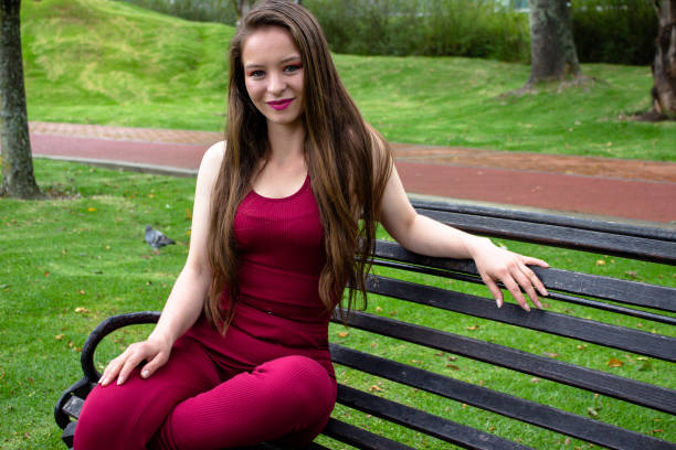 Beautiful young woman posing in a public park