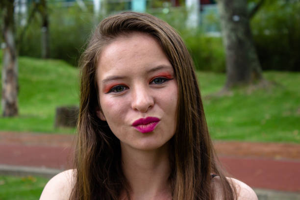 istock Beautiful young woman posing in a public park 2147664318