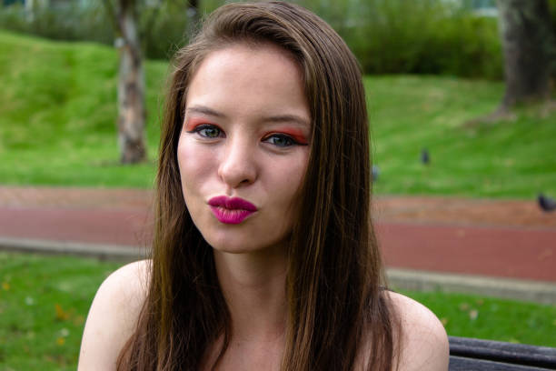 Beautiful young woman posing in a public park