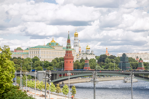 View of the Kremlin, Armoury Chamber, Borowizki Turm, Cathedral of the Archangel, Ivan the Great Bell-Tower from the Bolshoy Kamenny Bridge in the sunny day. Russia, Moscow, 07.22.2023