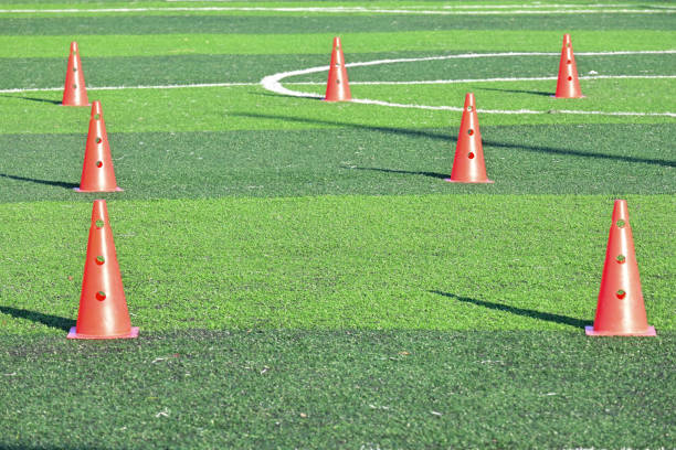 istock artificial green grass soccer field with orange training cones 2147667986