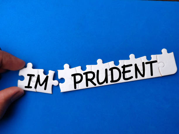 istock Hand holding white puzzle with text IM PRUDENT on blue background 2147668375