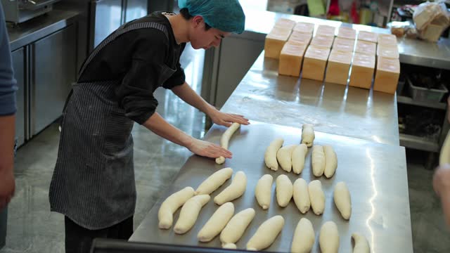 Asian employees making bread