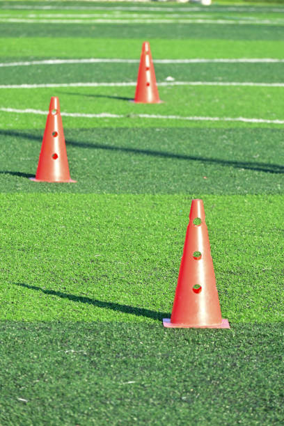 istock artificial green grass soccer field with orange training cones 2147668840