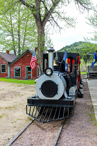This small train takes passengers on a ride to Nevada city This train is located in Virginia city Montana and takes riders to Nevada city ghost town Montana which is located next to it.
