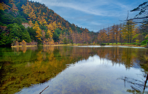 Idyllic landscape of Myojin pond in Kamikochi, Nagano, Japan (Japanese language meaning \