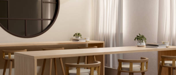 istock A long wooden table with stools in a contemporary minimalist cafe co-working space. 2147669648