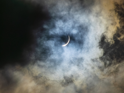 The barely visible sun moment right after total solar eclipse on a cloudy day on April 8, 2024.  The cloud covers the sun most of the time during total eclipse.  Taken in Richardson, Texas.