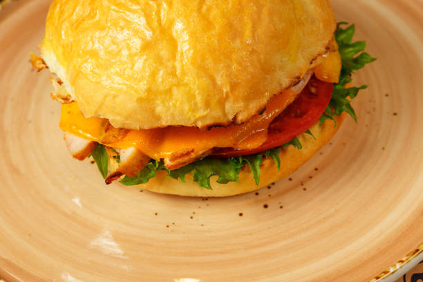 istock Cheeseburger topped with fresh lettuce and tomato on a sesame seed bun, ready to be enjoyed. 2147671341