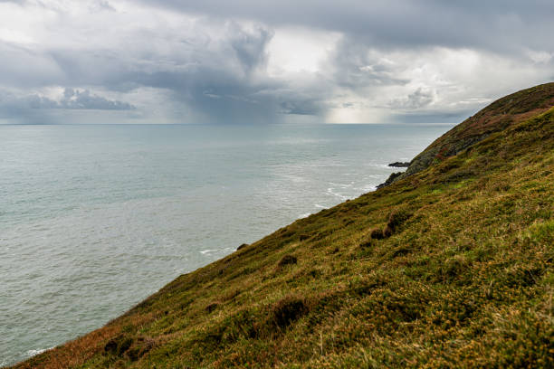 Photo of Howth Cliffs, Dublin, Ireland. Cloudy landscape with Ireland coastline and North Sea. Howth Cliffs Walk.