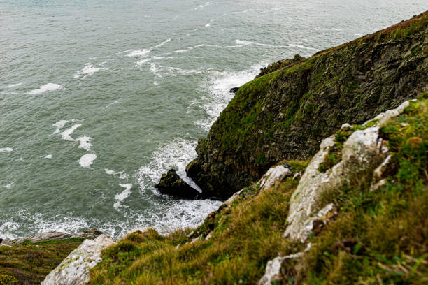 Photo of Howth Cliffs, Dublin, Ireland. Cloudy landscape with Ireland coastline and North Sea. Howth Cliffs Walk.