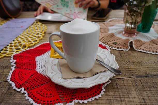 Foamy cappuccino in an artistic outdoor setting at LX Factory in Alcantara, Lisbon, Portugal