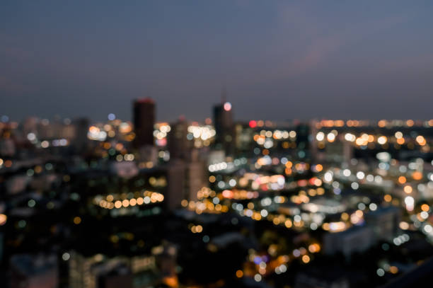 istock Blurred twilight bokeh lights city office building, abstract background 2147672134