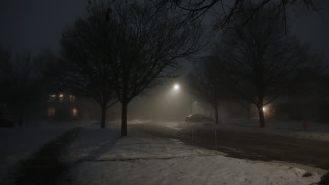 Dark street whit street light at night with heavy fog