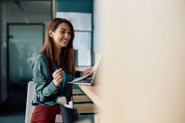 istock Young businesswoman using laptop and analyzing reports while working in the office. 2147673056
