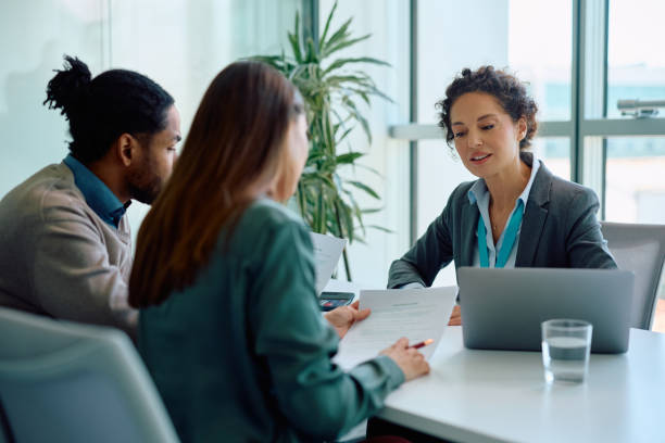 istock Financial advisor and her clients analyzing documents during a meeting in the office. 2147673179