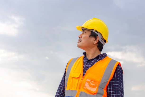 Portrait of Foreman worker in hardhat at the infrastructure construction site, Construction engineer at the building site
