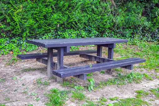 The table outside is wooden, with benches screwed on all sides, France, Saint Jean Pied de Port