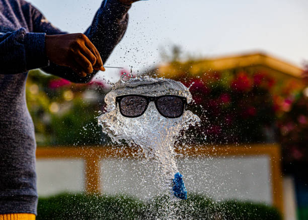 Colorful water balloons float in a tub on a hot summer day ahead of a fun activity.