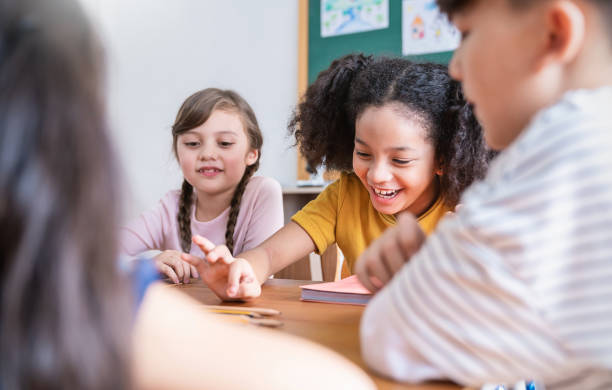 istock Group of pupil boy girl group study with teacher in classroom at elementary school. Student in primary school story telling. Children  classroom. Education knowledge, success teamwork concept banner 2147675323