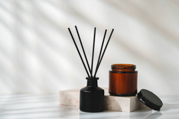 istock Elegant Aroma Diffuser With Black Reeds on a Marble Stand in Soft Daylight 2147675901