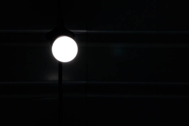 istock lamp burning in the dark. Energy saving. Blackout 2147676078