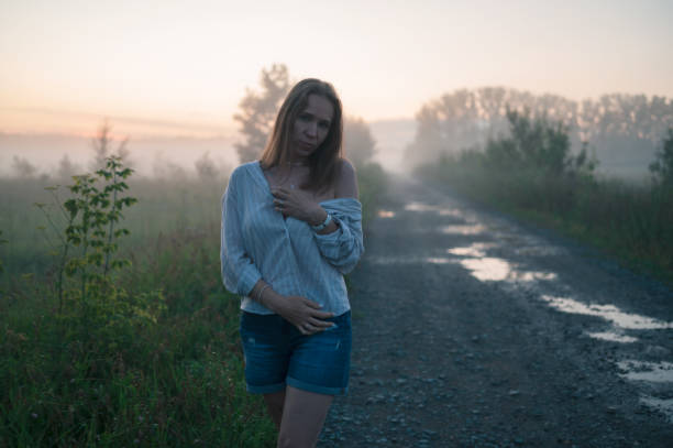 Woman in a field with misty fog