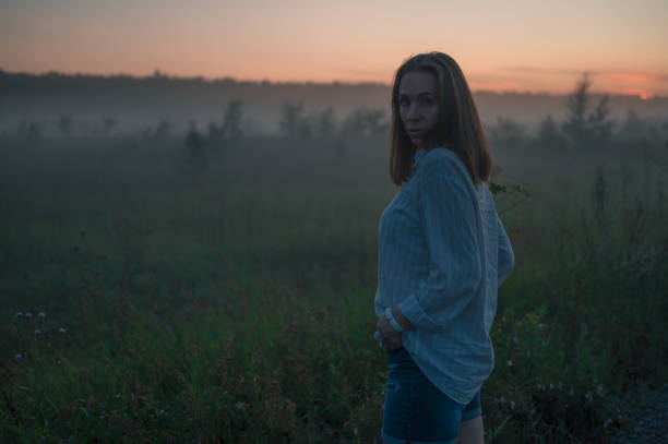 istock Woman in a field with fog 2147676652