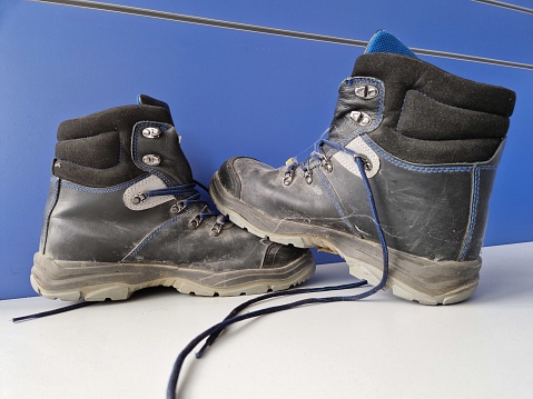 Protective working shoes close up photography. Black leather boots suitable for construction site works.