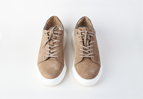 Pair of brown leather shoes isolated on a white background.
