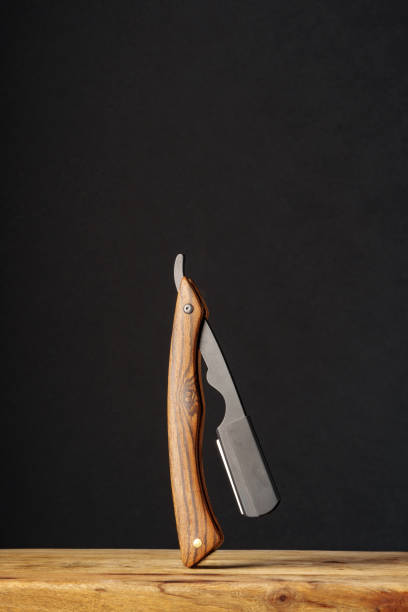 istock Handcrafted Wooden Folding Knife Displayed on a Rustic Table Against a Dark Background 2147677197