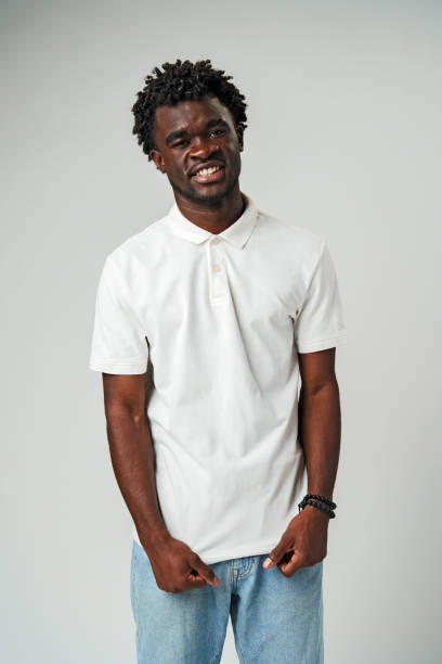 Young African Man Standing in White Shirt and Jeans