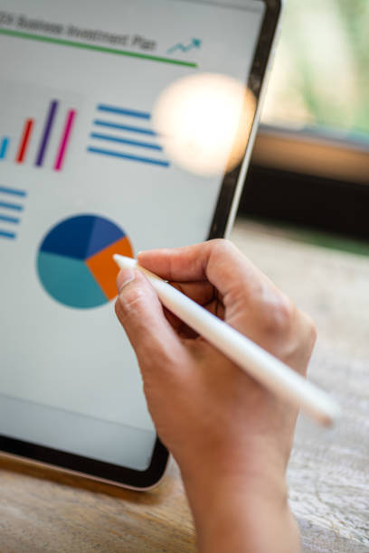 istock Working on business investment plan in tablet. 2147677317