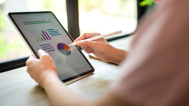 istock Working on business investment plan in tablet. 2147677339
