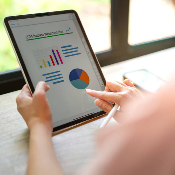istock Working on business investment plan in tablet. 2147677342
