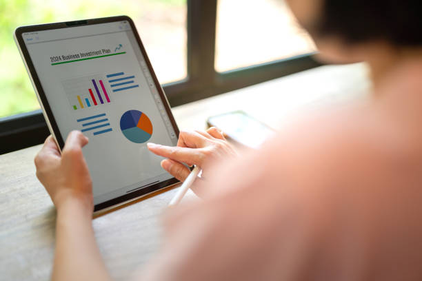 istock Working on business investment plan in tablet. 2147677349