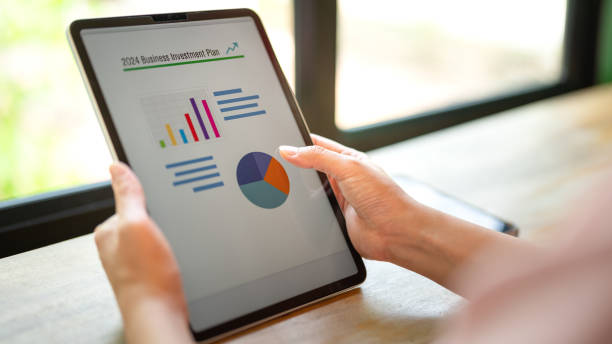 istock Working on business investment plan in tablet. 2147677352