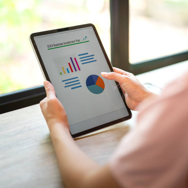 istock Working on business investment plan in tablet. 2147677356