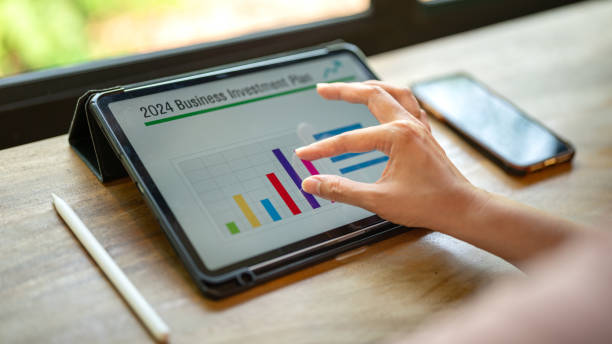 istock Working on business investment plan in tablet. 2147677371