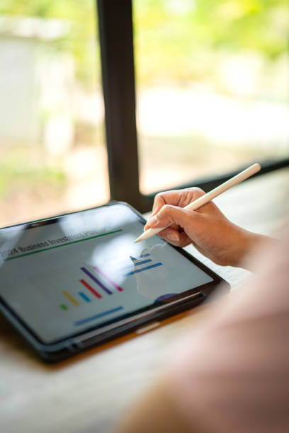 istock Working on business investment plan in tablet. 2147677380