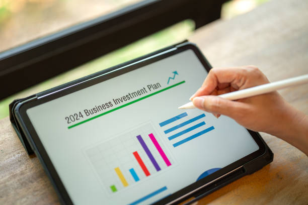 istock Working on business investment plan in tablet. 2147677401