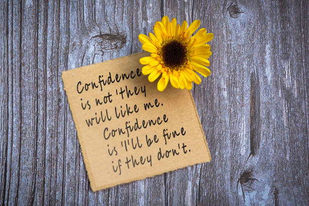 istock Motivational on brown note with gerbera yellow flower on wooden surface. 2147677602
