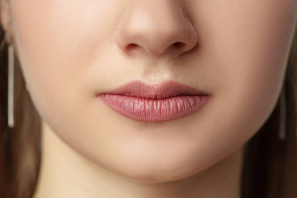 istock Part of face, young woman lips close up 2147677618