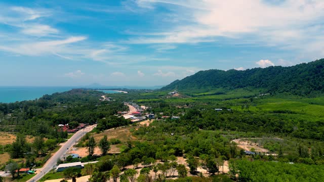 4K Cinematic nature drone footage of a panoramic aerial view of the beautiful beaches and mountains on the island of Koh Lanta in Krabi, South Thailand, on a sunny day