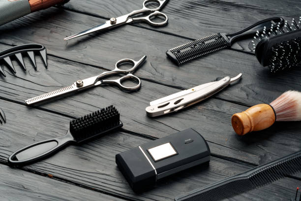 istock Professional Barber Tools Laid Out on Dark Wooden Surface 2147678428