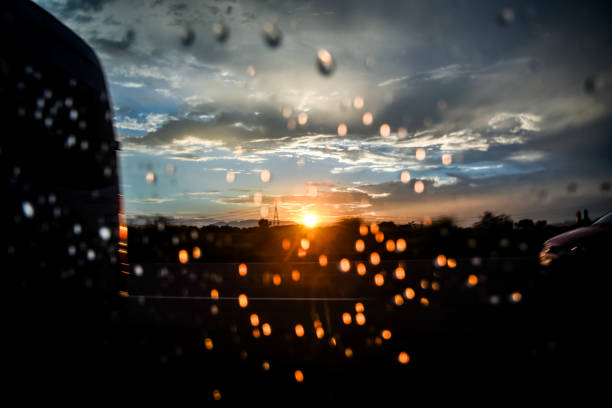 Raindrops on a windowpane at sunset.