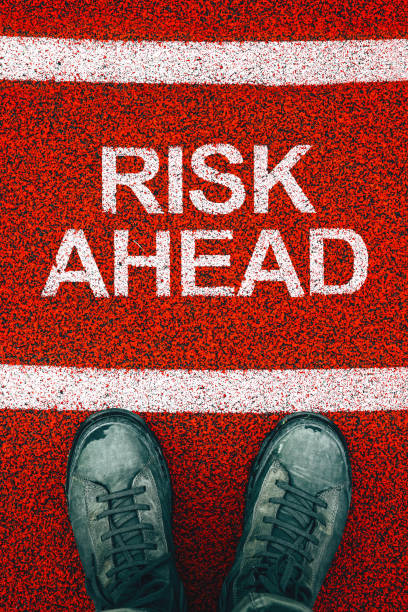 istock Risk ahead concept, male boots from above with text on the ground 2147679282