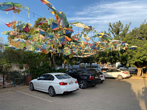 Famagusta, Cyprus - November 21, 2019: A bustling carnival parking lot filled with colorful tents and attractions