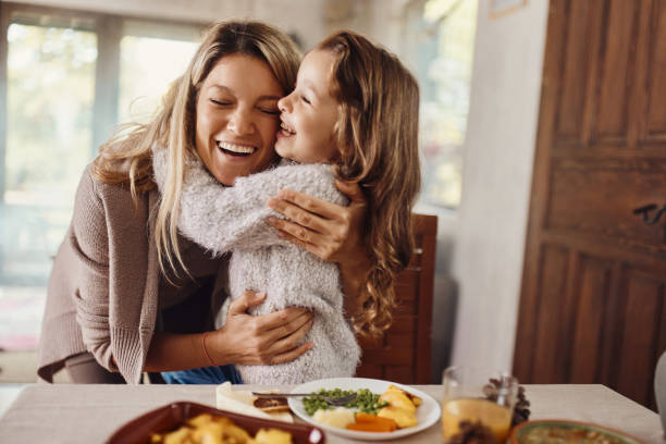 istock Happy single mother and daughter embracing at home. 2147680190