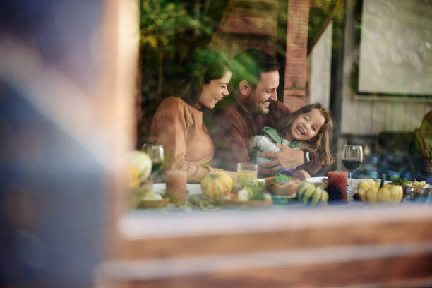 istock Cheerful parents having fun with their daughter at dining table. 2147680258